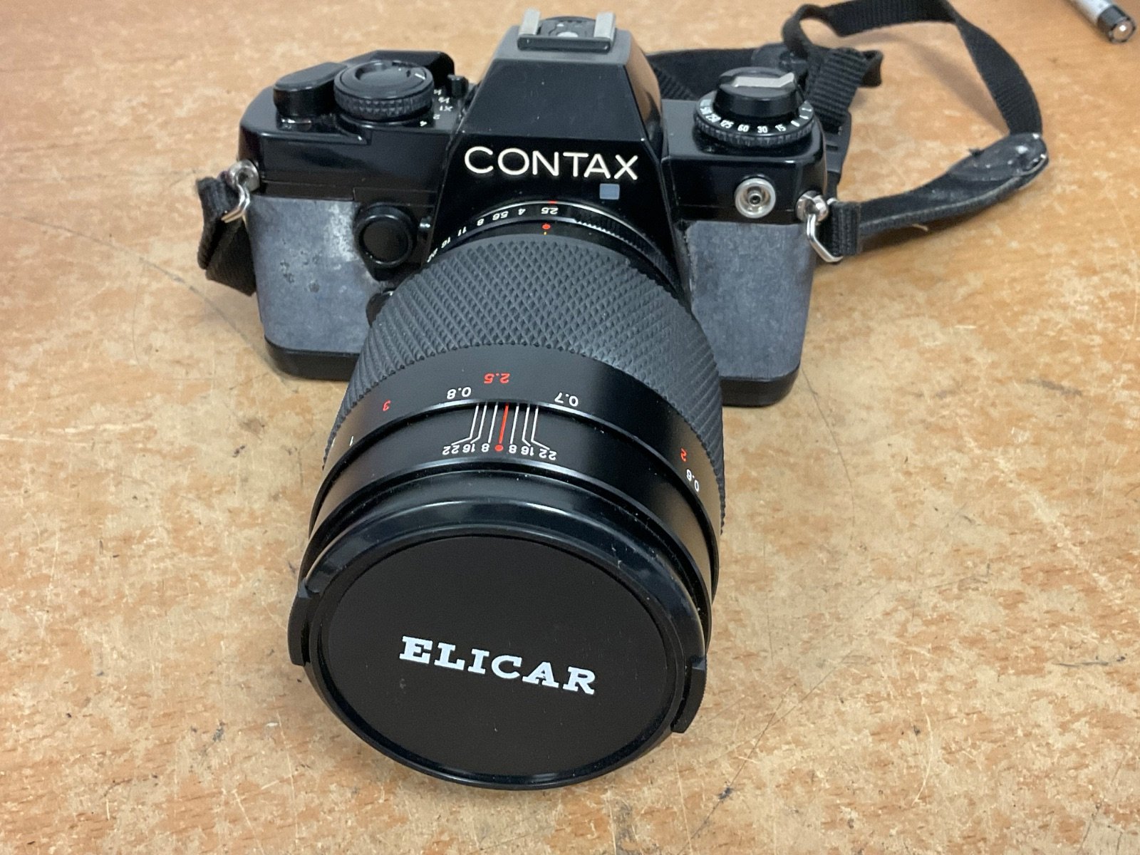 A Contax 139 Quartz 35mm SLR camera with an Elicar lens in used condition, showing signs of wear but functional.